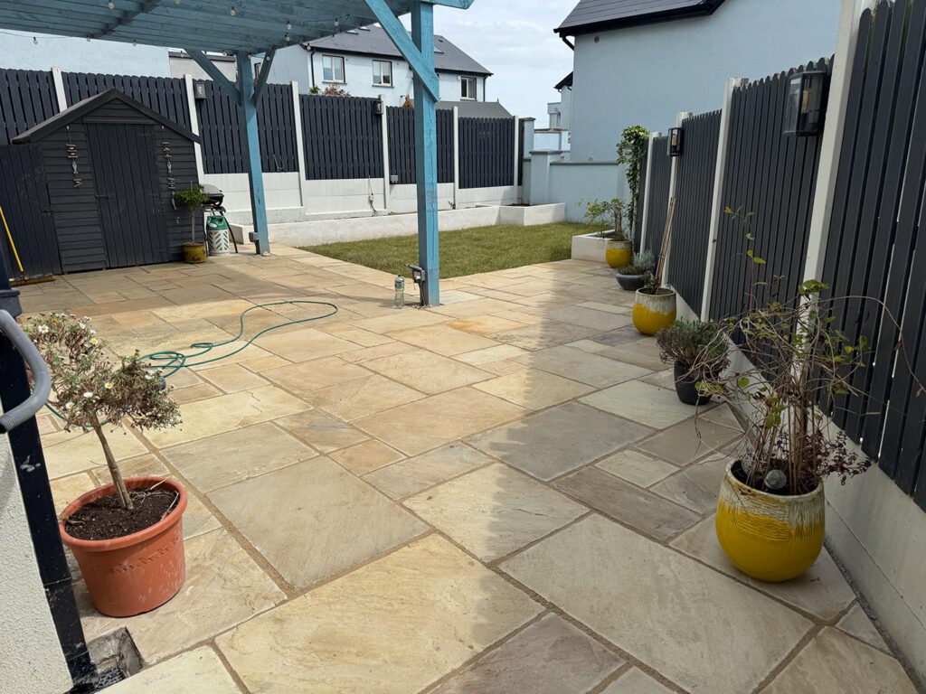 After — new sandstone patio, planter beds and fresh lawn in Skerries
