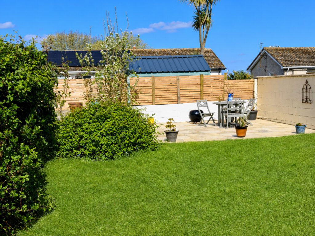 After — the same Skerries garden cleaned up with a new patio and a repaired wall