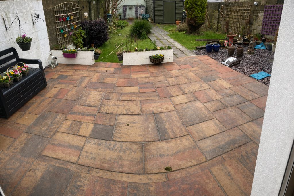After — the garden level raised with an Indian sandstone patio for safe, level access